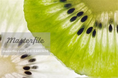 Close up image of a sliced kiwi with studio backlight