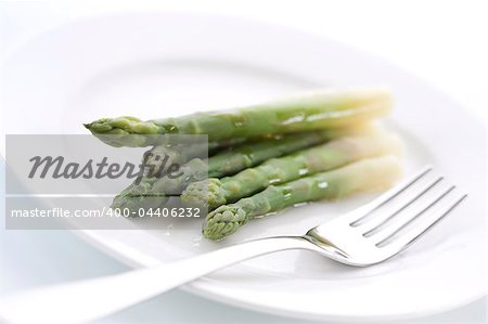 Boiled asparagus on the white plate
