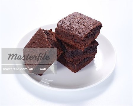 Chocolate brownies on white plate