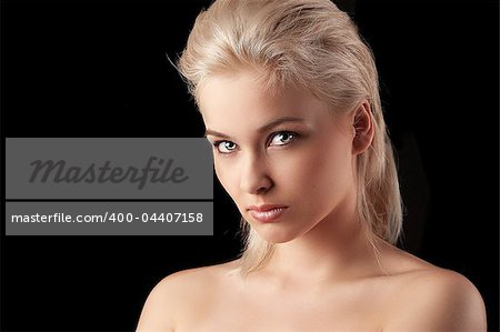 beauty closeup portrait of a young woman blonde woman looking straight into the camera