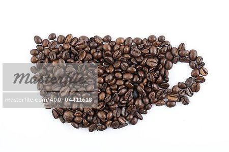 Coffee beans forming mug shape on white background