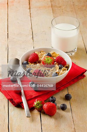 photo of delicious breakfast made of corn flakes with berries and fresh milk