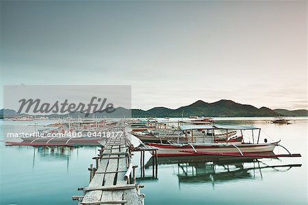 Wooden pier and bahgka boats in Coron