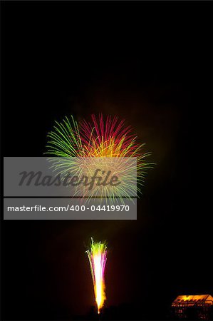 Beautiful fireworks exploding over a dark night sky in a grand finale display. Very high resolution.