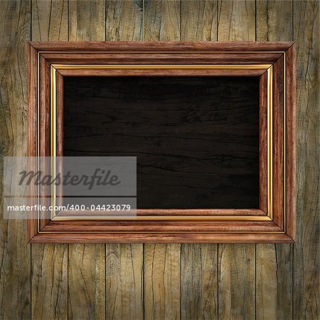 wooden picture frame on the old wooden wall.