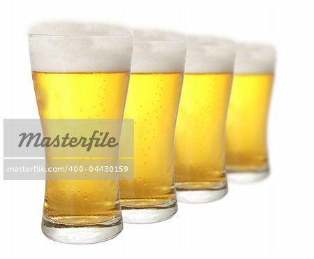 Four glasses of beer against white background