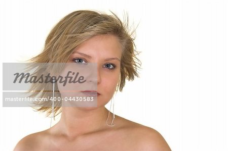Head and shoulders portrait of a pretty young woman looking at you; naked shoulders; wind blown hair; isolated on white.