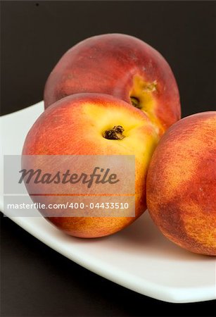 Necterines set against a plain background