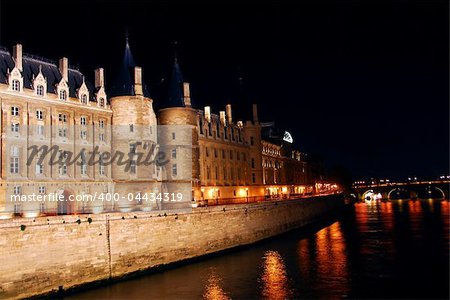 Bridges over Seine and Conciege in nighttime Paris France