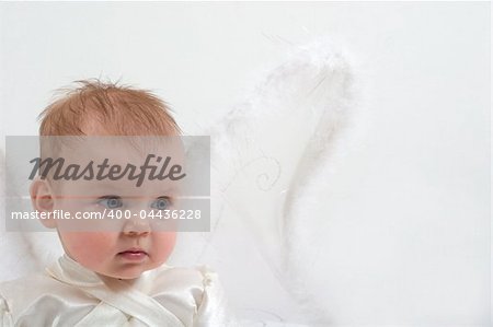 cute little girl dressed like fairy with fluffy wings is crying