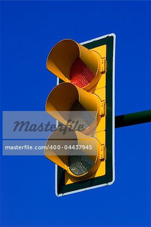 Red stop traffic light on blue sky