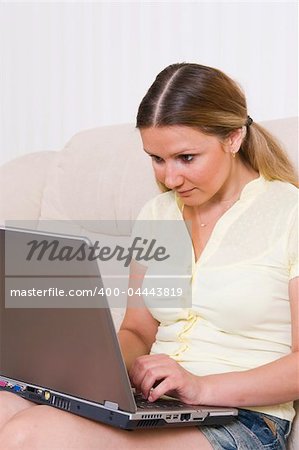 young pretty woman working at laptop computer