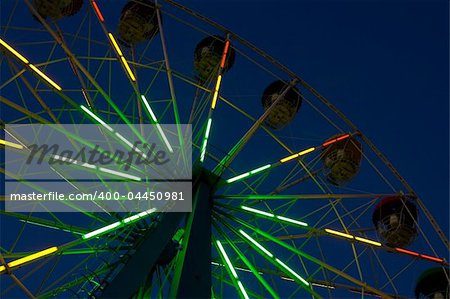 Abstract view of a colourful ferris wheel at night