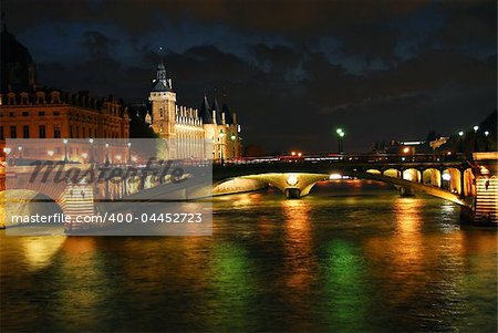 Bridges over Seine and Conciege in nighttime Paris France