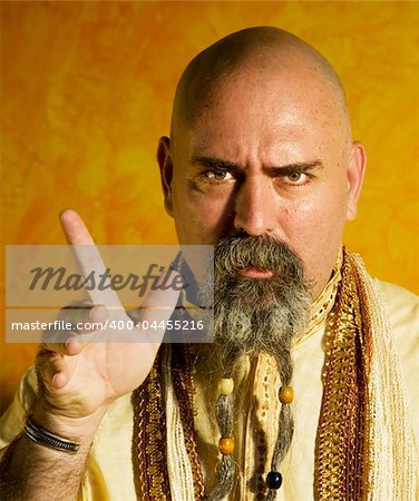 Funny bald guru with a long beaded beard.