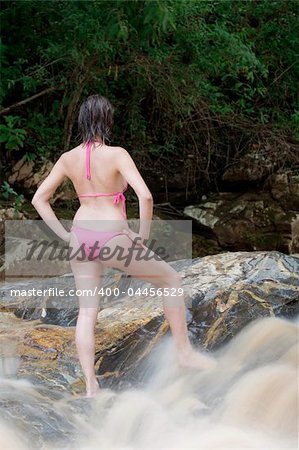 Beautiful Brazilian girl swimming in a local river