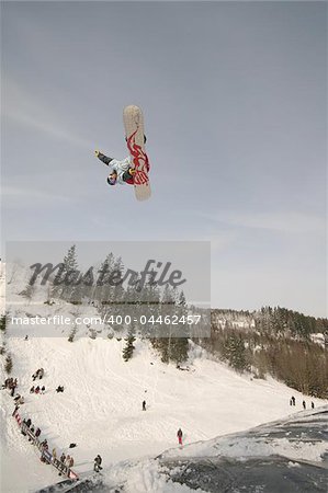 Daring snowboardrider taking off and grabbing at the Artic Challenge in Oslo