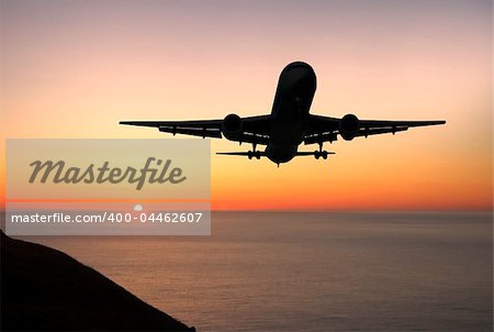 Large airliner approaching to land at sunrise