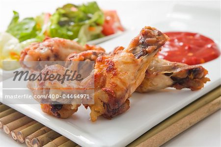 hot spices buffalo wings with salad and chili sauce