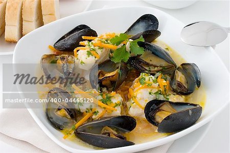 Haddock and mussel stew in a white plate