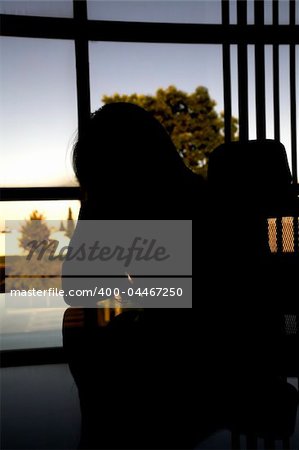 business woman indoor shot sitting depressed at her desk