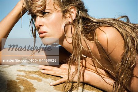 Portrait of pretty bare young Caucasian woman on beach.