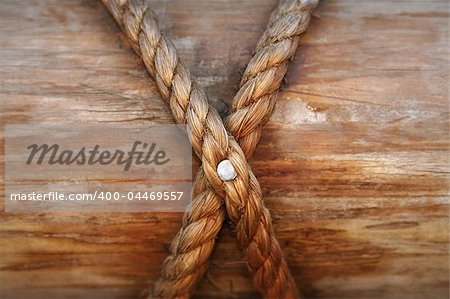 Rope, nail and wooden surface