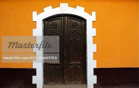 Black door, Yellow Wall on a colonial style building in Puno, Peru