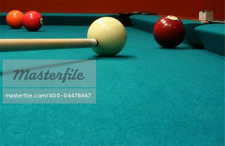 An image of some billiard balls with a cue stick