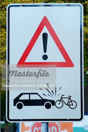 traffic sign with attention danger of accident car and cyclist