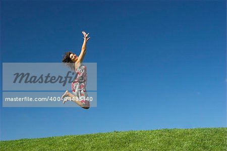 Happy woman on a beautiful green meadow