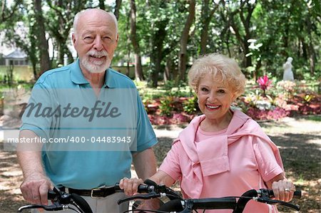 An attractive senior couple out for a bike ride together.