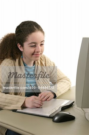 A teen girl drawing on a computer graphics tablet.