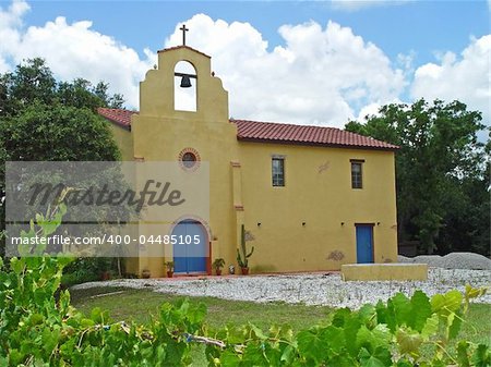 An old, Spanish mission style church in a vinyard.