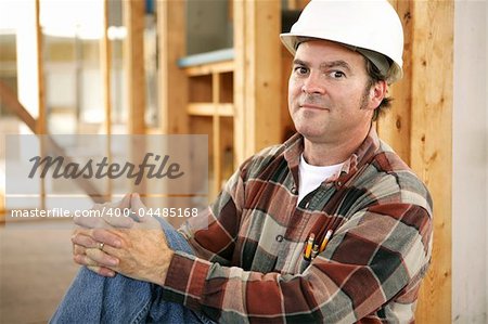 A construciton worker on the jobsite with a proud expression.  Authentic construction worker on actual construction site.