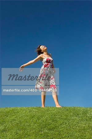 Happy woman having fun on a beautiful green meadow