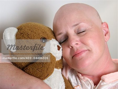 A medical patient cuddling with a teddy bear for comfort.