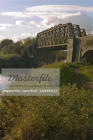 A derelict railway bridge over the river avon Stratford-upon-avon Warwickshire England.