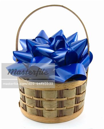 Blue bow inside a wicker basket on white background.
