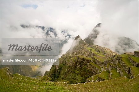 Machu Picchu underneath a cover of fog. (Peru)