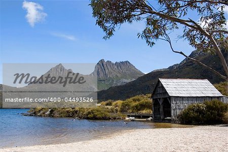 An old boathouse rests by the calm lakeside at Cradle Mountain in Australia's wild state of Tasmania.