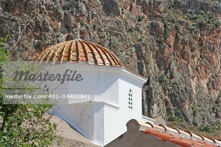 The tiled dome of a white church in the castle-town of Monemvasia, Greece