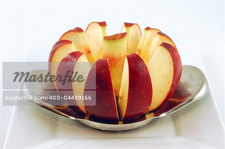 Cored red delicious apple on a white plate isolated on a white background