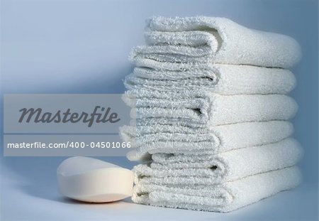 White towels and soap on a blue background