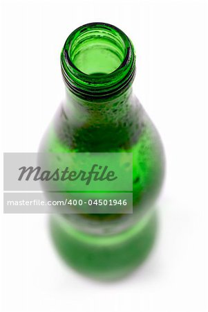 bottled water in green, condensation-covered bottle; differential focus
