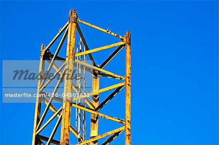 Yellow structure part against a blue sky