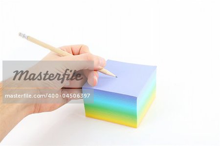 male hand writing on color paper over white