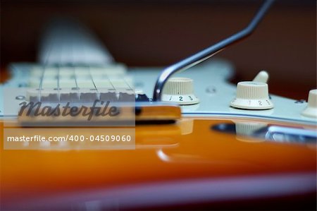 Close-up of a Fender American Deluxe guitar knobs and bridge