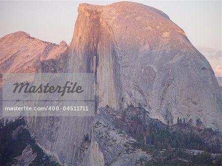 The alpine glow of sunset hits Yosemite National Parks Half Dome.