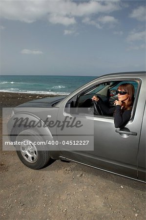 Woman and her 4wd car at Fuerteventura's beach